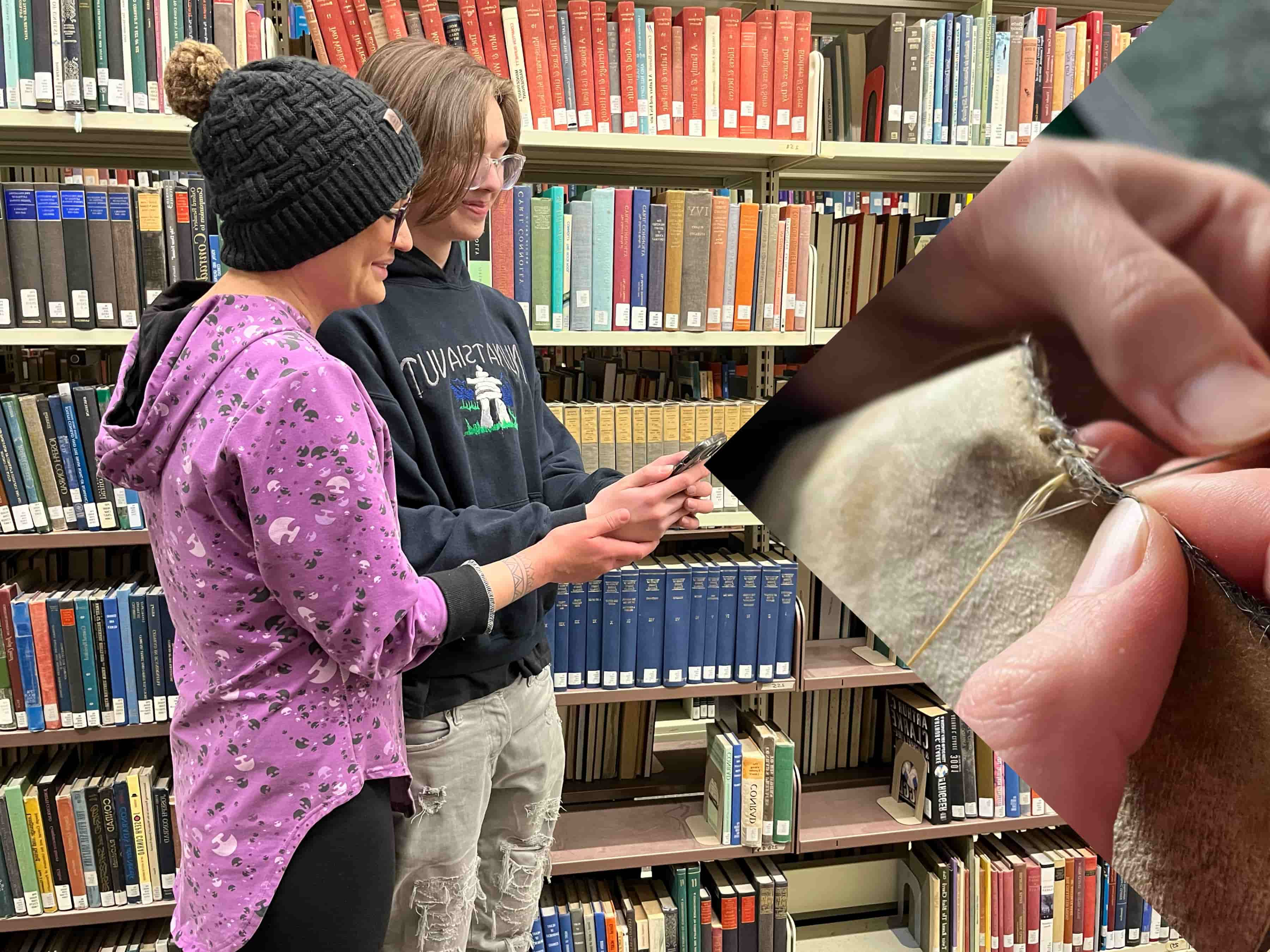 Students viewing traditional seal skin stitchwork.